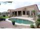 Backyard pool view of covered patio and landscaping with mature greenery at 13487 E Gold Dust Ave, Scottsdale, AZ 85259