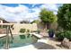 Enjoy a refreshing dip in this home's pool, set amidst lovely landscaping and hardscape features at 13487 E Gold Dust Ave, Scottsdale, AZ 85259