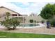 Backyard pool features rock landscaping and privacy wall with green grass at 13487 E Gold Dust Ave, Scottsdale, AZ 85259