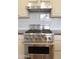 The kitchen features a stainless steel Viking oven and range hood at 13487 E Gold Dust Ave, Scottsdale, AZ 85259