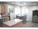 Bright dining area with wood-look tile flooring, adjacent to the kitchen at 1353 S Western Skies Dr, Gilbert, AZ 85296