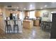 Spacious kitchen with stainless appliances, tile floors and breakfast bar seating at 1353 S Western Skies Dr, Gilbert, AZ 85296