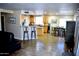 Open concept living room with a dining area, breakfast bar and wood-look tile floors at 1353 S Western Skies Dr, Gilbert, AZ 85296