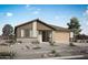 Inviting single-story home with brick accents, desert landscaping, and a two-car garage on a sunny day at 14776 W El Cortez Pl, Surprise, AZ 85387