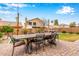 Spacious backyard with patio, outdoor dining, and landscaping, perfect for entertaining at 1548 W Windhaven Ave, Gilbert, AZ 85233