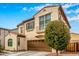 Charming two-story home features a brown two-car garage, stucco facade, and a delightful wrought-iron balcony at 1548 W Windhaven Ave, Gilbert, AZ 85233