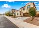 Charming two-story home features a brown two-car garage, stucco facade, and a delightful wrought-iron balcony at 1548 W Windhaven Ave, Gilbert, AZ 85233