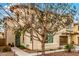 Charming two-story home features a brown two-car garage, stucco facade, and a delightful wrought-iron balcony at 1548 W Windhaven Ave, Gilbert, AZ 85233