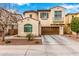 Charming two-story home features a brown two-car garage, stucco facade, and a delightful wrought-iron balcony at 1548 W Windhaven Ave, Gilbert, AZ 85233