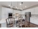 Bright kitchen with white cabinets, stainless steel appliances, quartz countertops, subway tile backsplash, and a kitchen island at 1548 W Windhaven Ave, Gilbert, AZ 85233