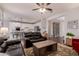 Spacious living room shows the open floor plan with the dining and kitchen areas in the background at 1548 W Windhaven Ave, Gilbert, AZ 85233