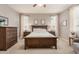 Neutral-toned main bedroom featuring a ceiling fan and plush carpeting at 1548 W Windhaven Ave, Gilbert, AZ 85233