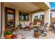 Covered patio with outdoor seating, decorative rug, and string lights, offering a comfortable outdoor living space at 1548 W Windhaven Ave, Gilbert, AZ 85233