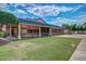 Exterior view of community clubhouse with a covered seating area and manicured lawn for outdoor enjoyment at 17200 W Bell Rd # 2125, Surprise, AZ 85374