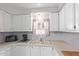 Bright kitchen area featuring white cabinets, a sink under a window and ample counter space at 17200 W Bell Rd # 2125, Surprise, AZ 85374