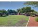 Park playground featuring a slide, trees for shade and well-maintained landscaping in a planned community at 17200 W Bell Rd # 2125, Surprise, AZ 85374