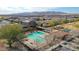 An aerial view of a community pool, tennis courts, and landscaped streets at 17322 W Jessie Ln, Surprise, AZ 85387