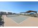 A sunny view of the community tennis court surrounded by desert landscaping at 17322 W Jessie Ln, Surprise, AZ 85387