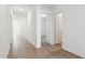 Hallway with tile flooring leading to bedrooms, offering a seamless and welcoming transition throughout the home at 18345 W Gray Fox Trl, Wittmann, AZ 85361