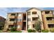 Multi-story condo building with balconies and well-maintained landscaping at 18416 N Cave Creek Rd # 2063, Phoenix, AZ 85032