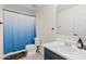 Bathroom featuring a shower with blue gradient curtain and a vanity with white countertop at 1978 E Connemara Dr, San Tan Valley, AZ 85140