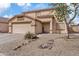 Two-story home with a two car garage, rock landscaping, and tile roof under a partly cloudy blue sky at 1978 E Connemara Dr, San Tan Valley, AZ 85140