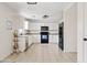 Bright open kitchen with white cabinets, a black oven, and tiled flooring at 1978 E Connemara Dr, San Tan Valley, AZ 85140