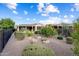 Spacious backyard with gravel landscaping, privacy shrubs and views of neighboring homes at 21854 N 263Rd Dr, Buckeye, AZ 85396