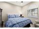 Comfortable bedroom with a large window and stylish blue and white bedding at 21854 N 263Rd Dr, Buckeye, AZ 85396