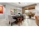 Bright dining area with modern chandelier, slider to backyard, and a beautiful mirror above the dark table at 21854 N 263Rd Dr, Buckeye, AZ 85396