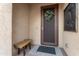 Charming front entryway featuring a decorative screen door, welcome wreath, and cozy bench at 21854 N 263Rd Dr, Buckeye, AZ 85396