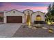 Inviting single-story home featuring a desert-style front yard, stucco exterior, and a two-car garage at 21854 N 263Rd Dr, Buckeye, AZ 85396