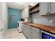 Well-appointed laundry room featuring gray cabinetry, wood countertop, and accent lighting with a stylish flair at 21854 N 263Rd Dr, Buckeye, AZ 85396