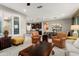 Open-concept living area showcases tile flooring, bright windows, and seamless flow into the kitchen and dining spaces at 21854 N 263Rd Dr, Buckeye, AZ 85396