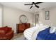 Comfortable main bedroom featuring an accent chair, a dresser, and a ceiling fan at 21854 N 263Rd Dr, Buckeye, AZ 85396