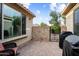 Cozy outdoor patio with stone accent wall, wrought iron gate, and comfortable seating area at 21854 N 263Rd Dr, Buckeye, AZ 85396