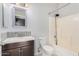 Functional bathroom featuring a mosaic backsplash, updated vanity, and a shower-tub combination at 219 E Valley View Dr, Phoenix, AZ 85042