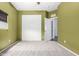 Bright bedroom features neutral carpet, green walls, large closet, and ceiling fan at 219 E Valley View Dr, Phoenix, AZ 85042