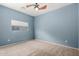 Bright bedroom with neutral carpet, ceiling fan and window with natural lighting at 219 E Valley View Dr, Phoenix, AZ 85042