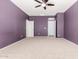 Spacious bedroom with neutral carpet, ample lighting, and convenient access to closet and doorway at 219 E Valley View Dr, Phoenix, AZ 85042