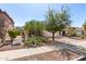 Single-story home with two-car garage and desert landscaping, including cacti and mature trees at 219 E Valley View Dr, Phoenix, AZ 85042