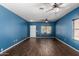 Spacious living room with hardwood floors, ceiling fan and bright natural light from window at 219 E Valley View Dr, Phoenix, AZ 85042