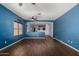 Open-concept living room with hardwood floors, ceiling fan, and view to other rooms at 219 E Valley View Dr, Phoenix, AZ 85042