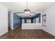 Open-concept living room with wood-look floors, and natural lighting at 219 E Valley View Dr, Phoenix, AZ 85042