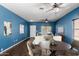 Inviting living room featuring ceiling fans, a table with chairs, and comfortable seating at 219 E Valley View Dr, Phoenix, AZ 85042