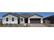 Charming single-story home featuring a well-maintained front yard and attached two-car garage at 24098 N 172Nd Ave, Surprise, AZ 85387