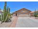 A charming desert home with a two-car garage and beautiful, low-maintenance landscaping at 2416 E Santiago Trl, Casa Grande, AZ 85194