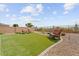 Relaxing backyard retreat featuring lush synthetic grass and comfortable lounge furniture at 24275 N 173Rd Ave, Surprise, AZ 85387