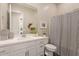 Well-lit bathroom with a white vanity, modern fixtures, decorative accents, and a shower-tub combination at 24275 N 173Rd Ave, Surprise, AZ 85387