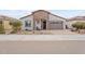 Charming single-Gathering home featuring a well-manicured front yard and cozy porch seating at 24275 N 173Rd Ave, Surprise, AZ 85387